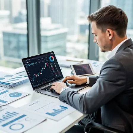 Professional real estate investment analysis scene, consultant reviewing property market data on laptop with financial charts and documents on desk, modern office environment, realistic photography, high resolution, clean corporate style
